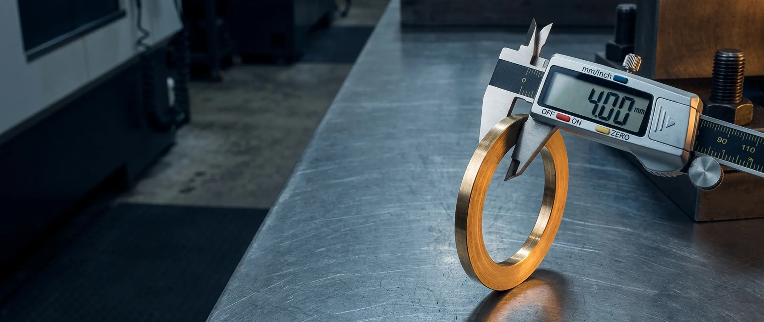 Digital caliper gripping the edge of a precision-cut gasket